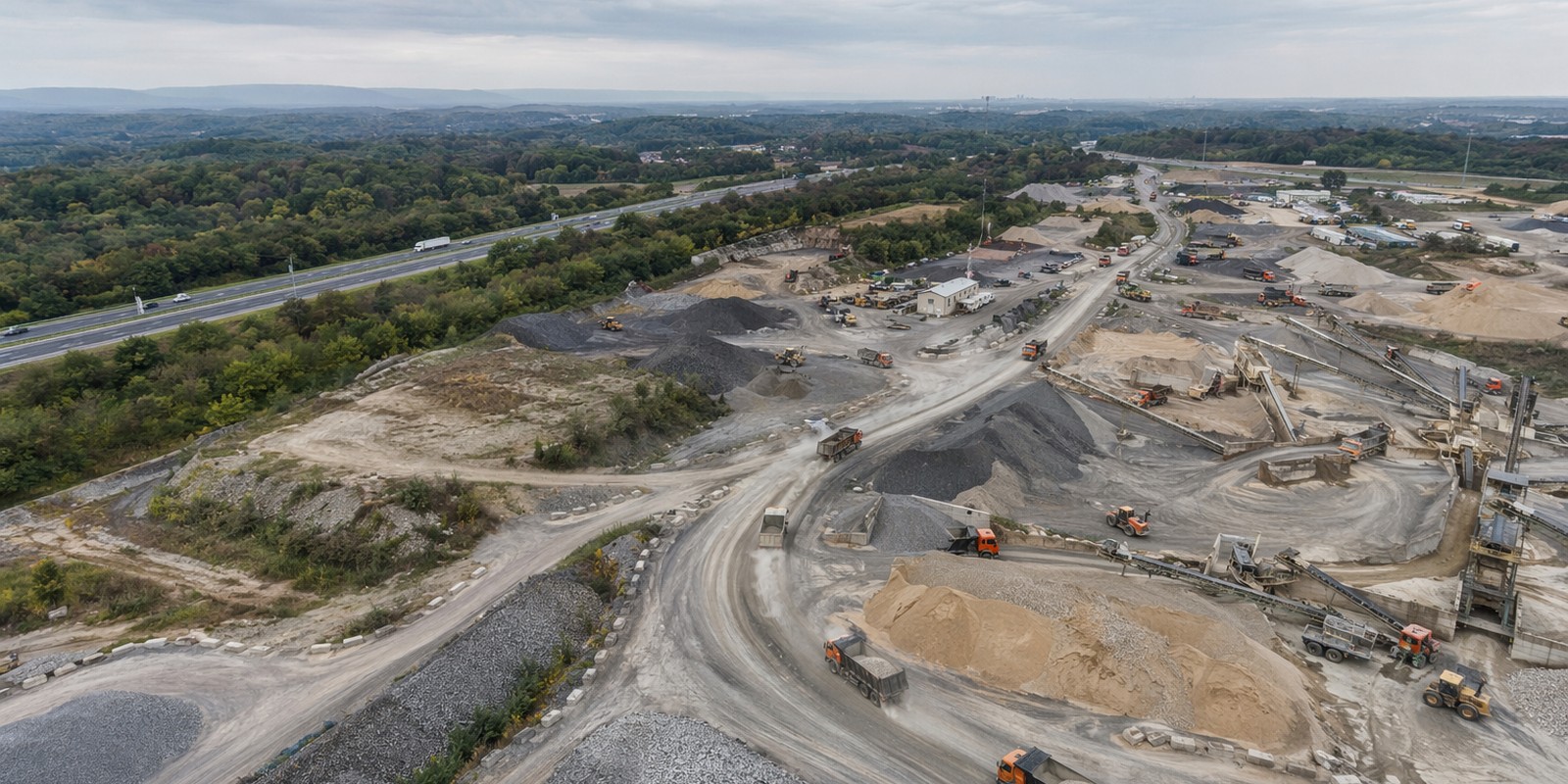 Aerial view of a Laney materials yard with stockpiles, haul roads, and truck traffic across the region