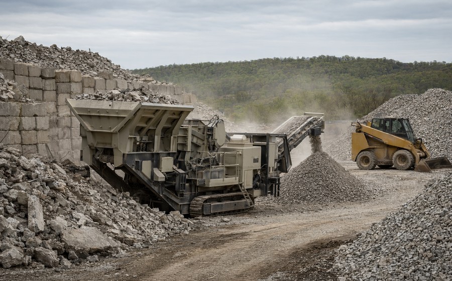 Recycled concrete aggregate being crushed and processed at a recycling yard